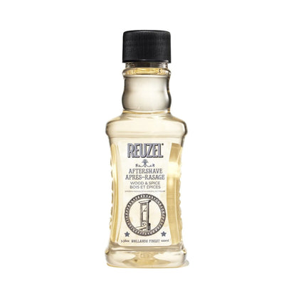 Reuzel Wood & Spice beard aftershave bottle with a wooden cap and label, showcasing a warm, woody and spicy scent.