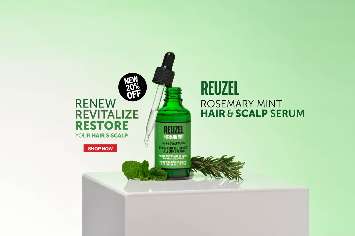 A green glass dropper bottle of Reuzel Rosemary Mint Hair & Scalp Serum displayed on a white pedestal with mint leaves and rosemary sprigs against a light green gradient background.