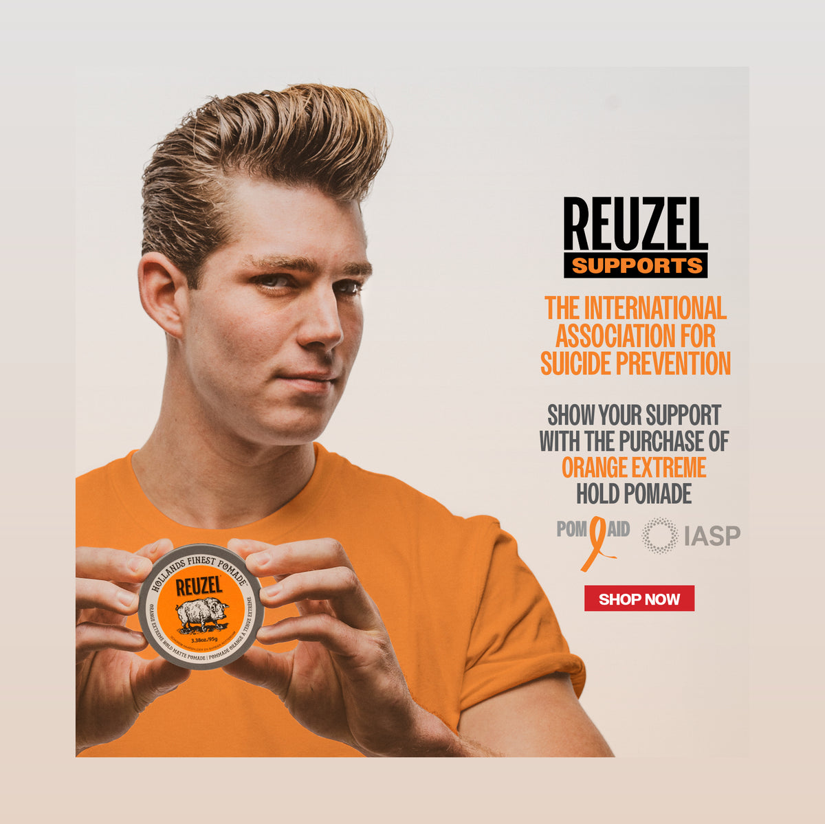 A promotional graphic for Reuzel Supports featuring a man in an orange T-shirt holding a tin of orange pomade. Text on the left reads 'REUZEL SUPPORTS' with 'THE INTERNATIONAL ASSOCIATION FOR SUICIDE PREVENTION' and a 'SHOP NOW' button.