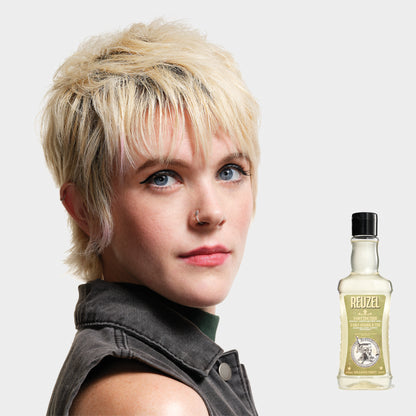 Reuzel Road Trip To Go 3-in-1 Tea Tree Shampoo, Conditioner, and Body Wash bottle with label and cap on white background.