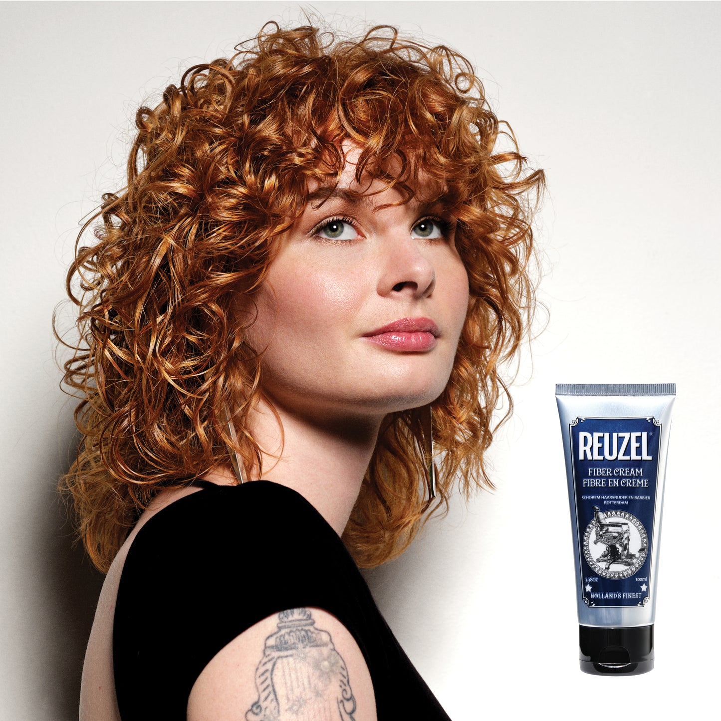 Reuzel Fiber Cream hair styling product in a jar, showing its thick, fiber-rich texture for flexible hold and natural finish.