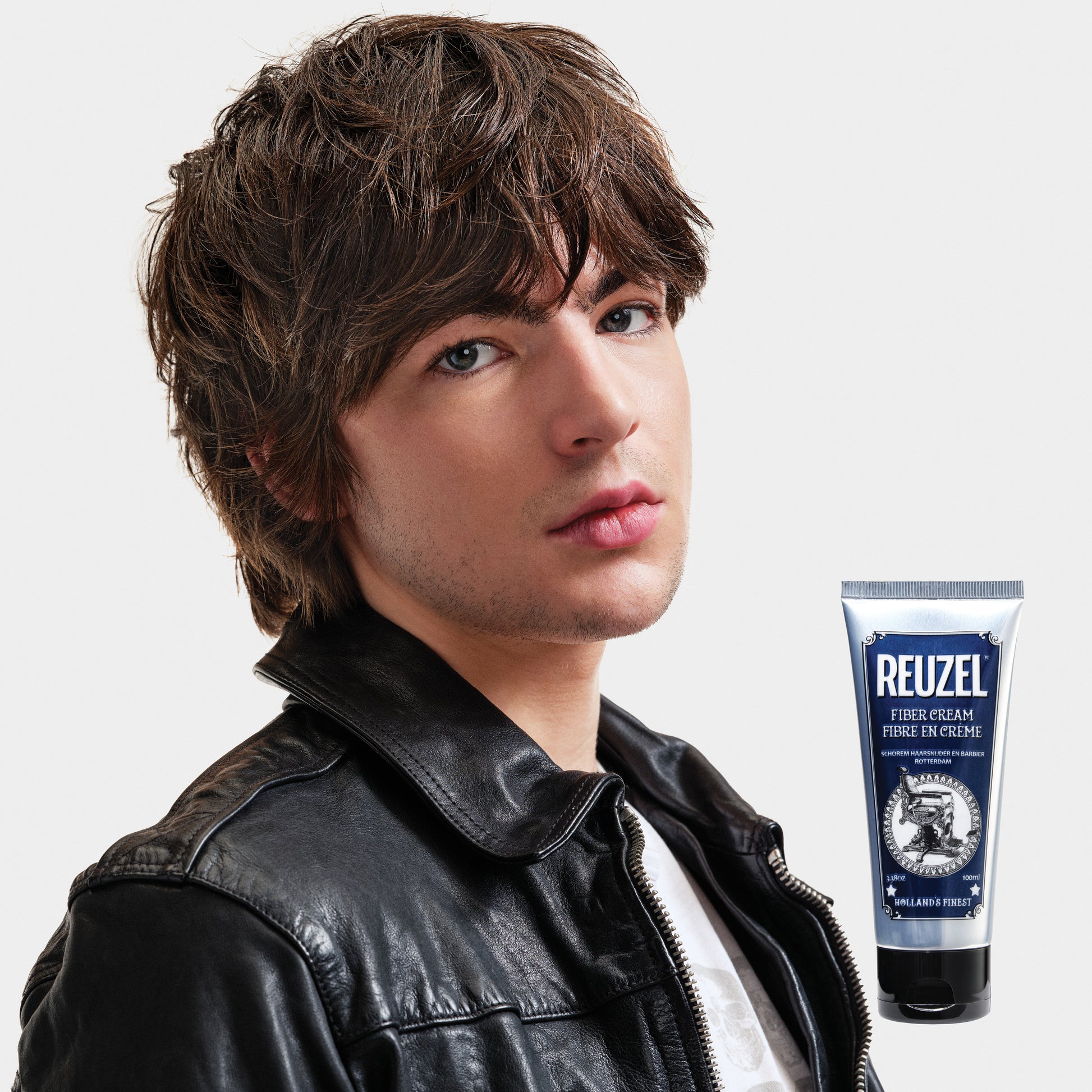 Reuzel Fiber Cream hair styling product in a jar, showcasing its thick, matte texture ideal for textured hairstyles.