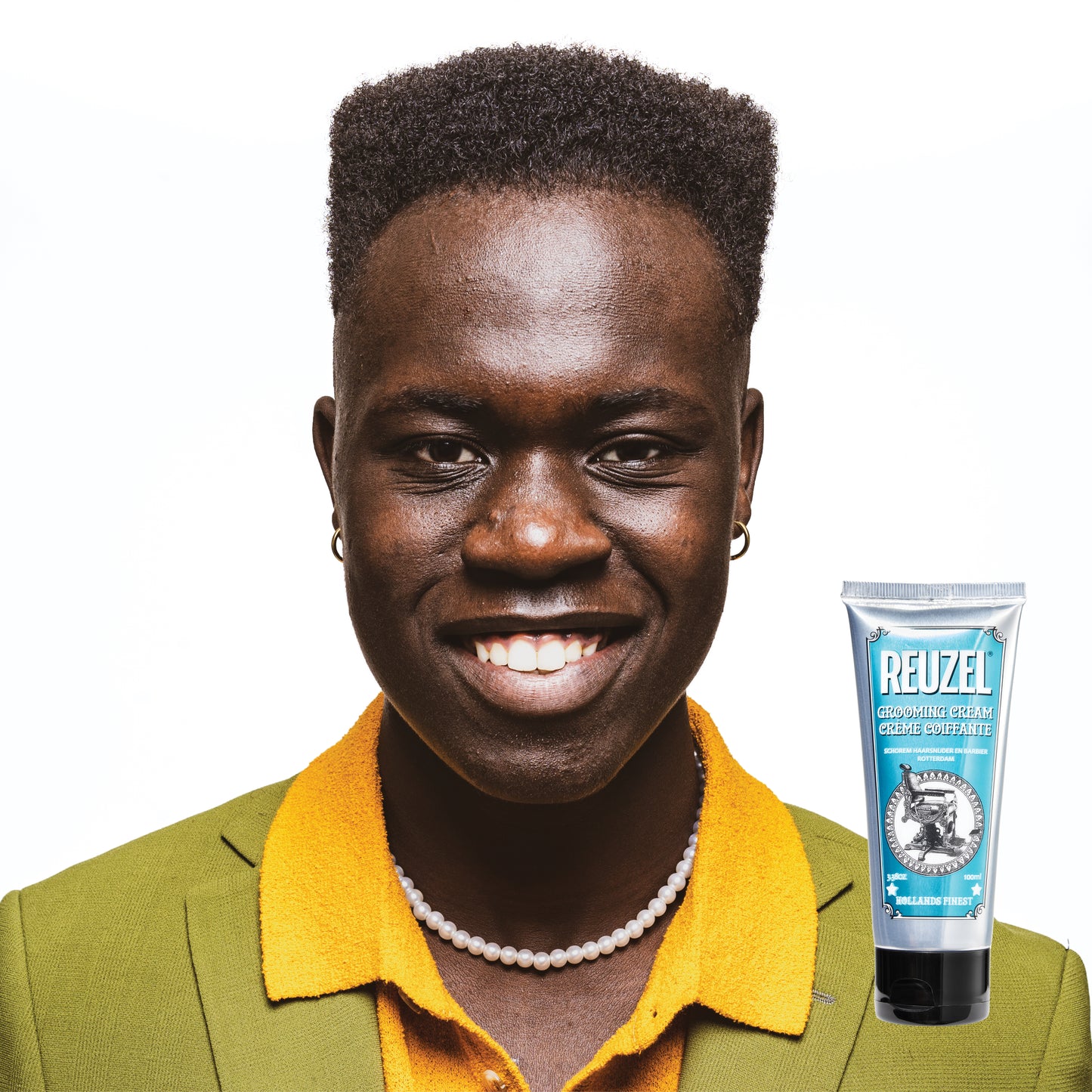 Reuzel grooming cream for hair styling, showing a jar of grooming cream with a textured finish and branding on the label.
