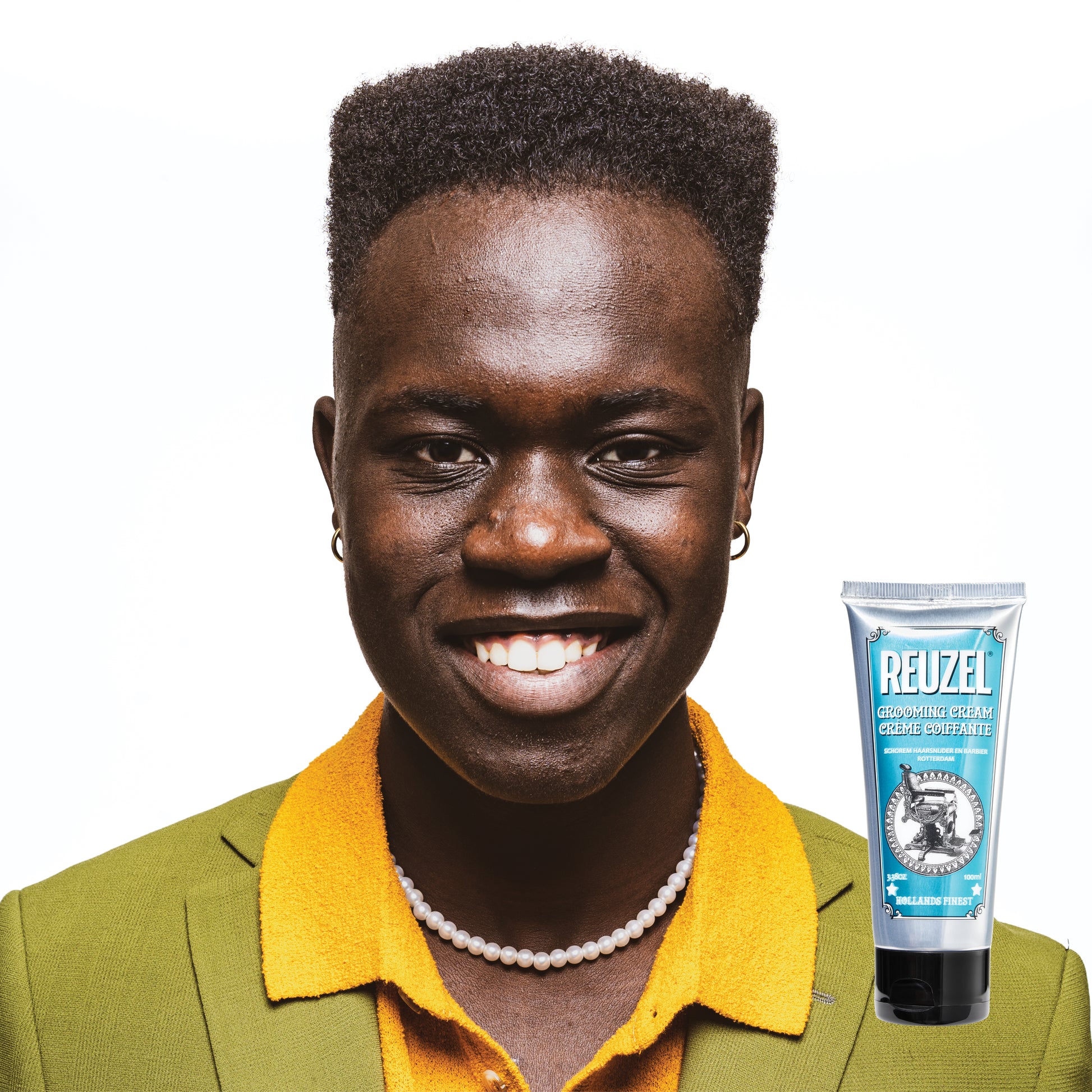 Reuzel grooming cream for hair styling, showing a jar of grooming cream with a textured finish and branding on the label.