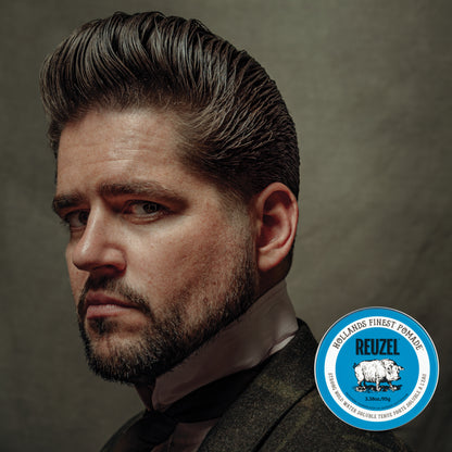 Reuzel Road Trip To Go Blue Pomade jar with blue label and lid, showcasing the grooming product for styling hair.