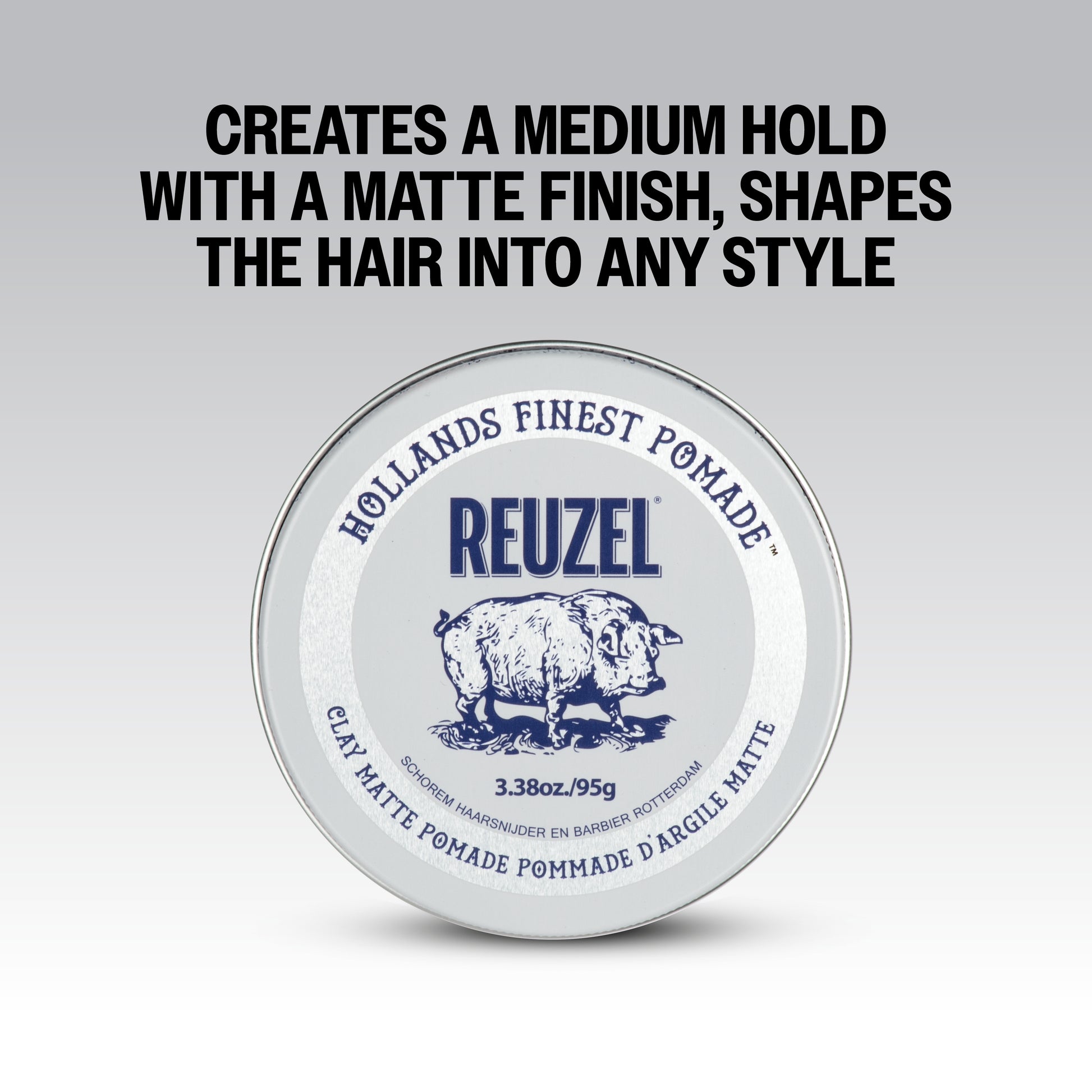 Reuzel Road Trip To Go Clay Pomade jar with black lid and label, showing the product container for styling hair.
