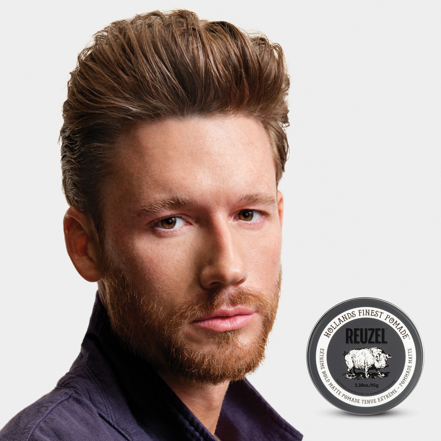 Reuzel Road Trip To Go Extreme Hold Matte Pomade jar with black lid and label, ideal for strong, matte hairstyle hold.