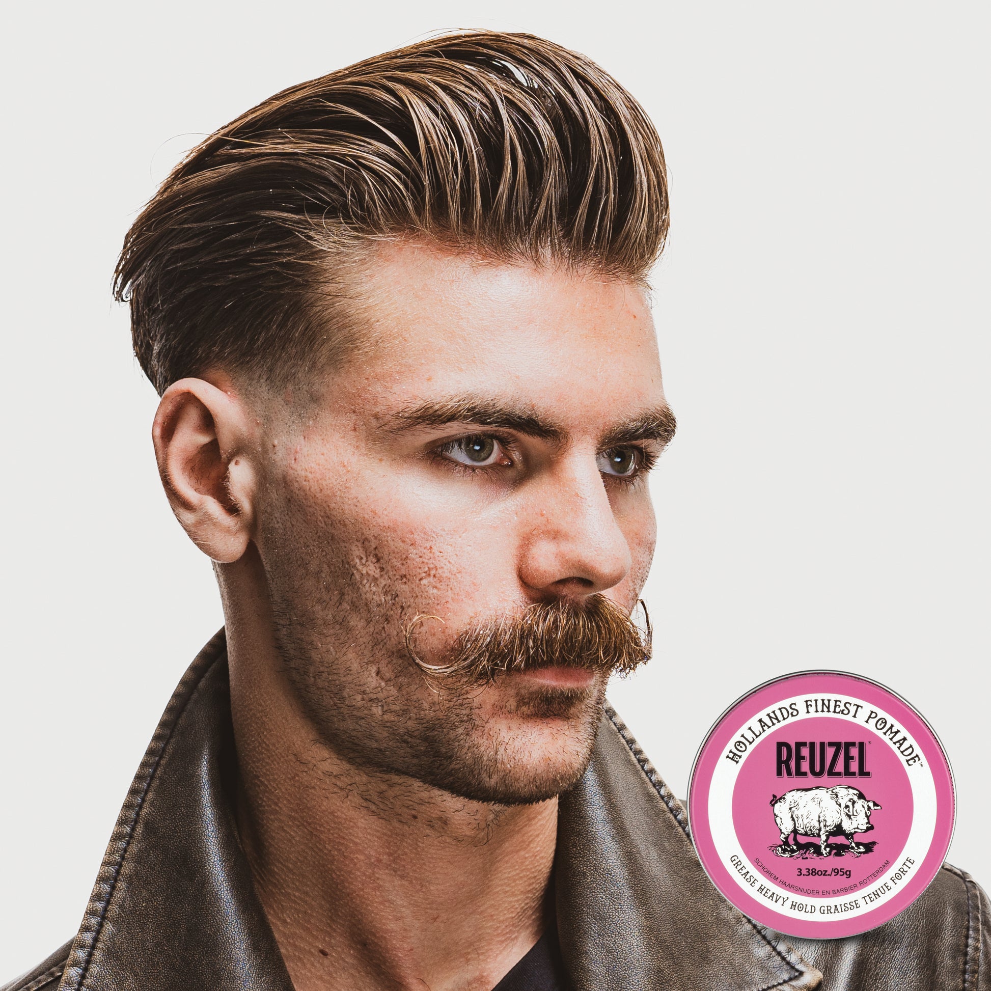 Pink Reuzel Pomade grease jar showing the smooth, glossy pink pomade inside with the brand label visible.