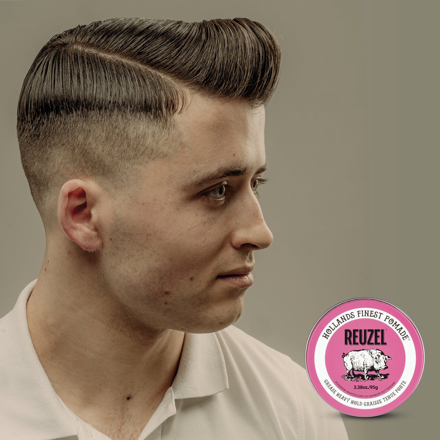 Pink Reuzel Pomade Grease jar with label, showcasing vibrant packaging and product details for classic hair styling.