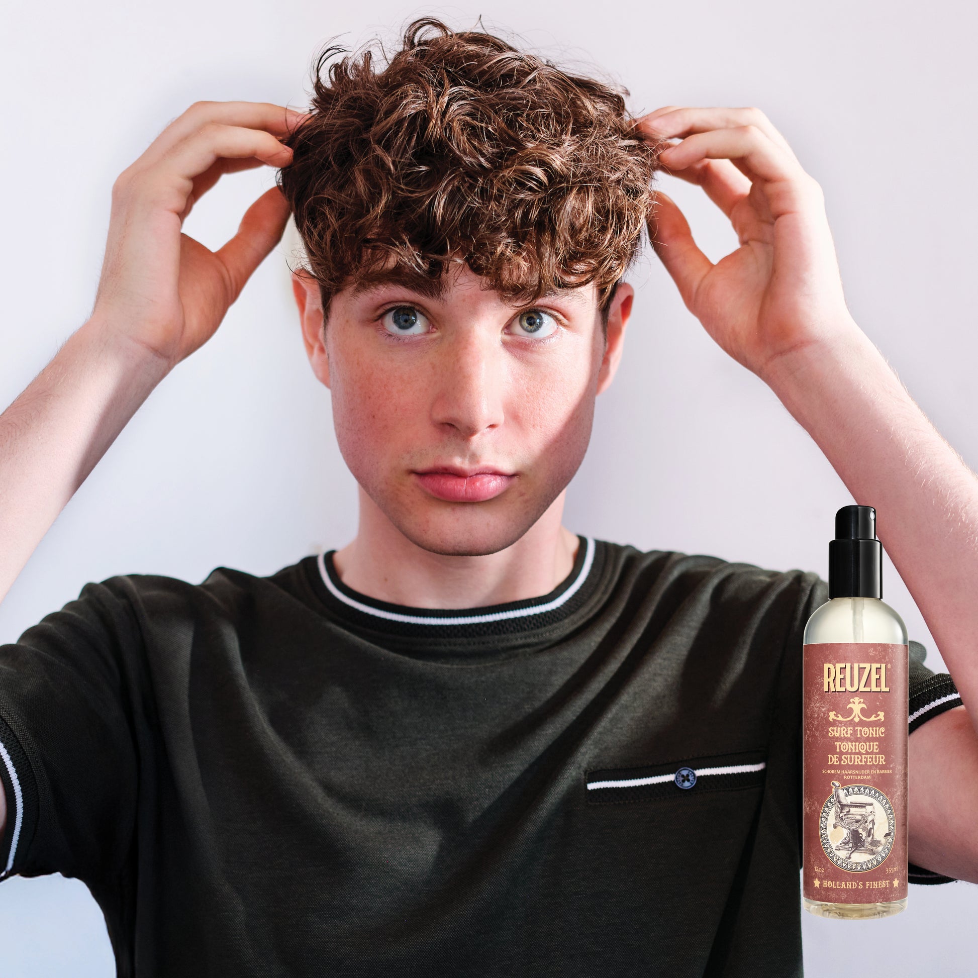 Reuzel Surf Tonic salt spray in a spray bottle, designed for textured beachy hair and adding volume to hair.