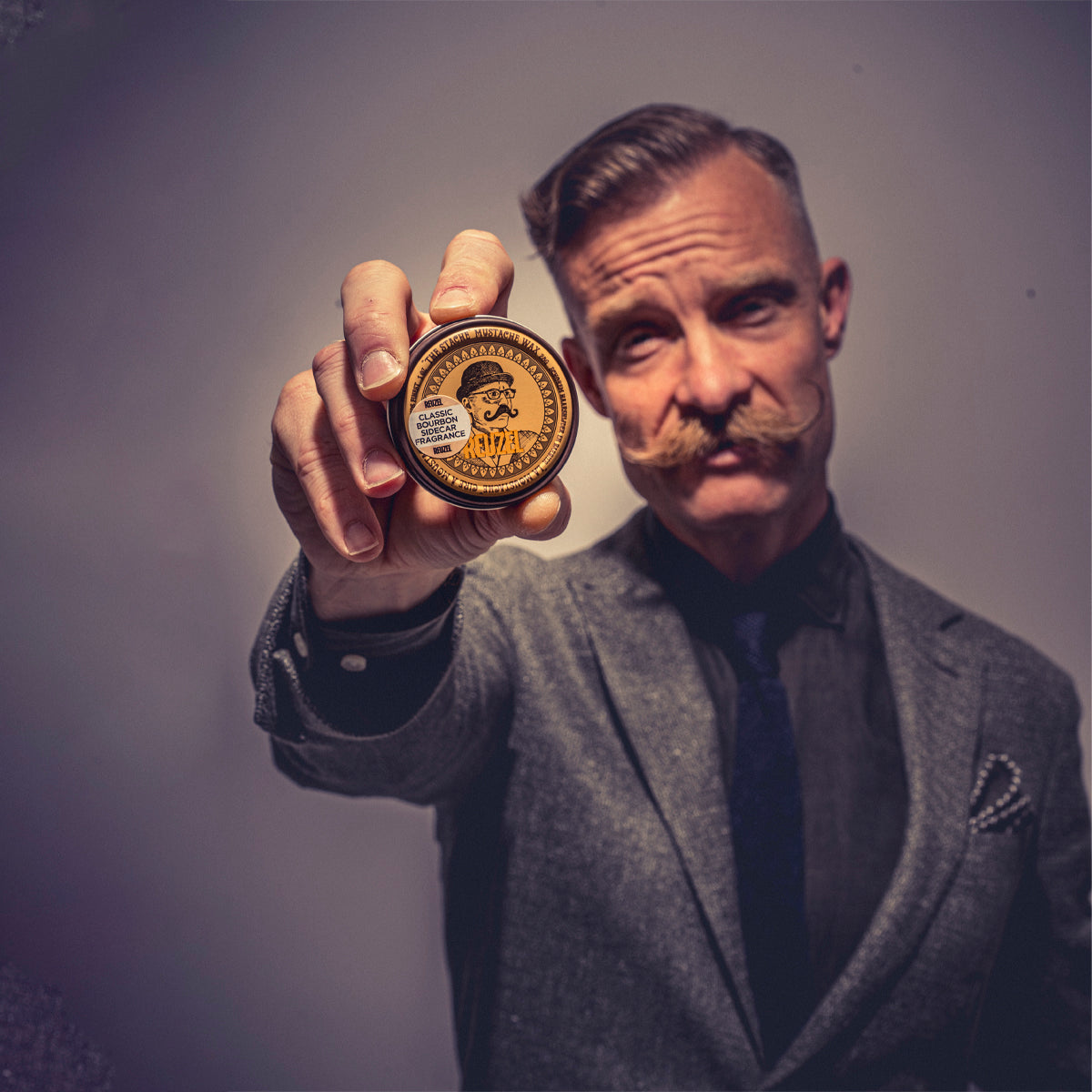 Reuzel Mustache Wax Bourbon Sidecar for beard styling, featuring natural finish and easy application in a compact container.