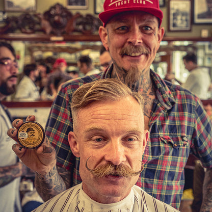 Reuzel Mustache Wax Bourbon Sidecar for styling mustaches, featuring a small tin of beard wax with bourbon scent.