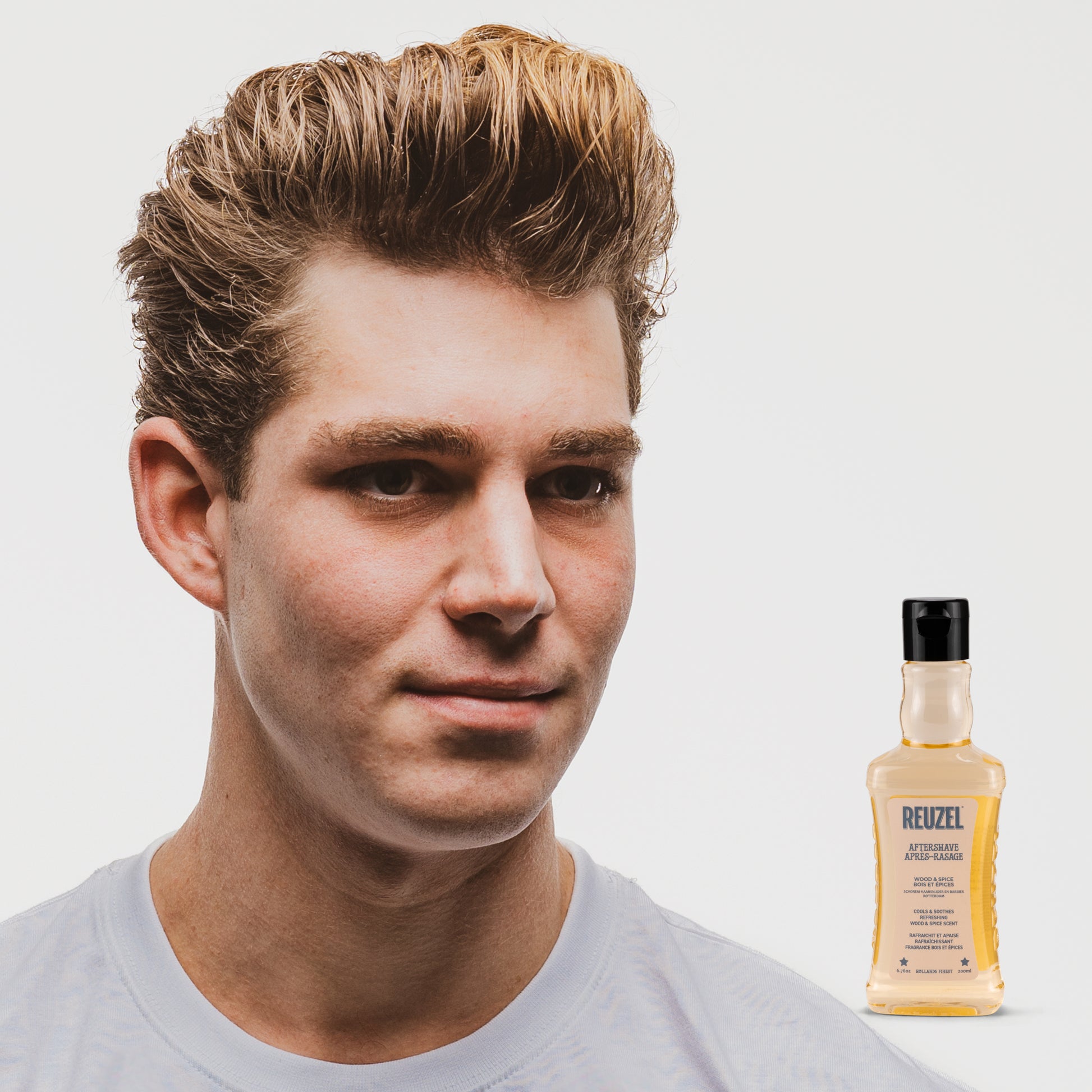 Reuzel Wood & Spice beard aftershave bottle with wood cap and spiced scent, part of Reuzel beard grooming products